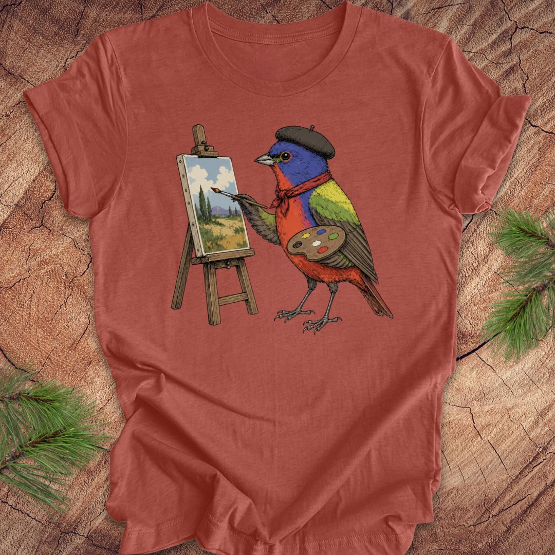 Clay colored t-shirt with a painted bunting bird painting on a wooden surface