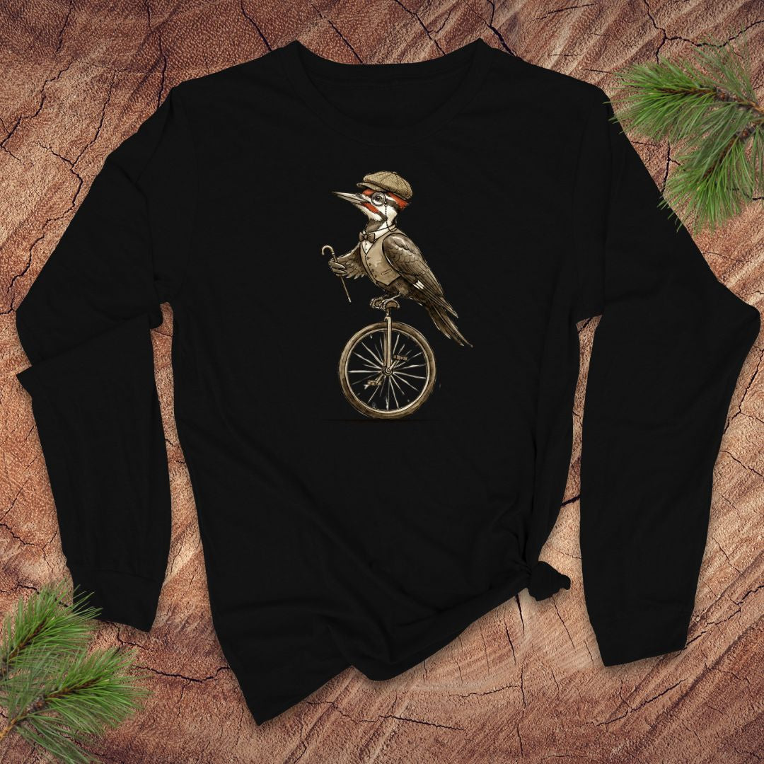 Black long-sleeve shirt with a woodpecker on a unicycle design on a wooden surface.