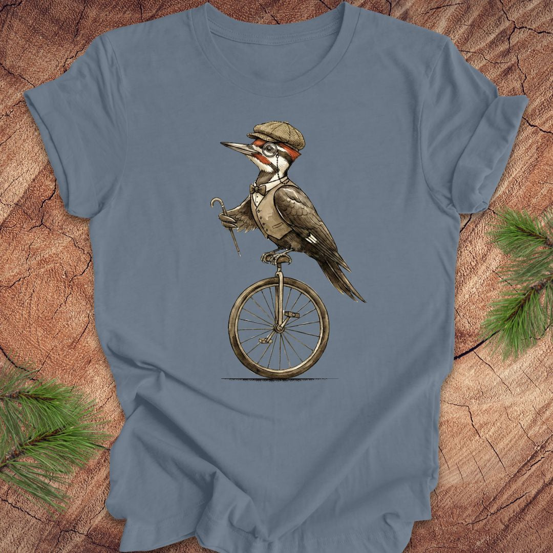 Blue t-shirt with a woodpecker character on a unicycle graphic on a wooden background