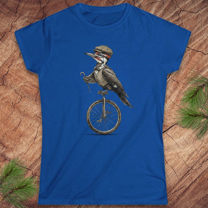 Blue t-shirt with a woodpecker on a unicycle graphic on a wooden surface.