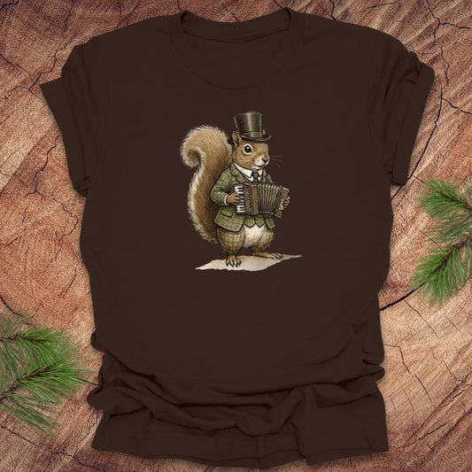 Brown t-shirt with a well dressed squirrel playing an accordion graphic on a wooden surface.