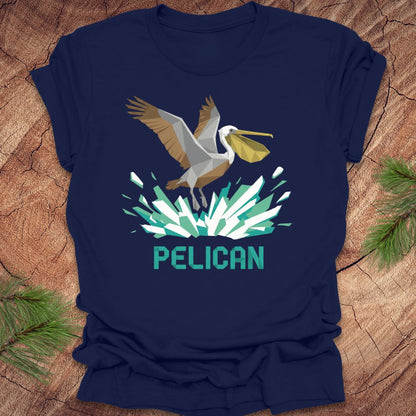 Navy blue t-shirt with a pelican graphic and 'PELICAN' text on a wooden surface.