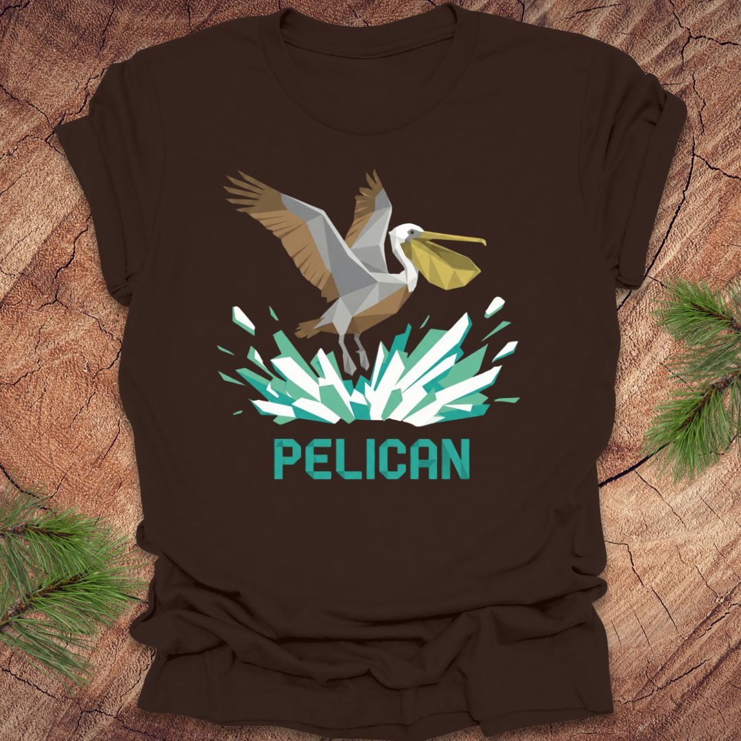 Brown t-shirt with a pelican graphic and 'PELICAN' text on a wooden surface.