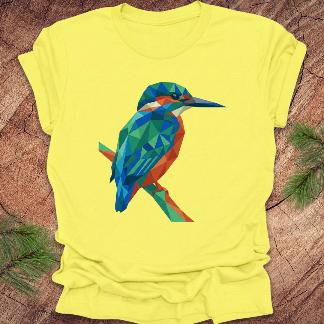 Yellow t-shirt with a colorful geometric kingfisher design on a wooden surface.