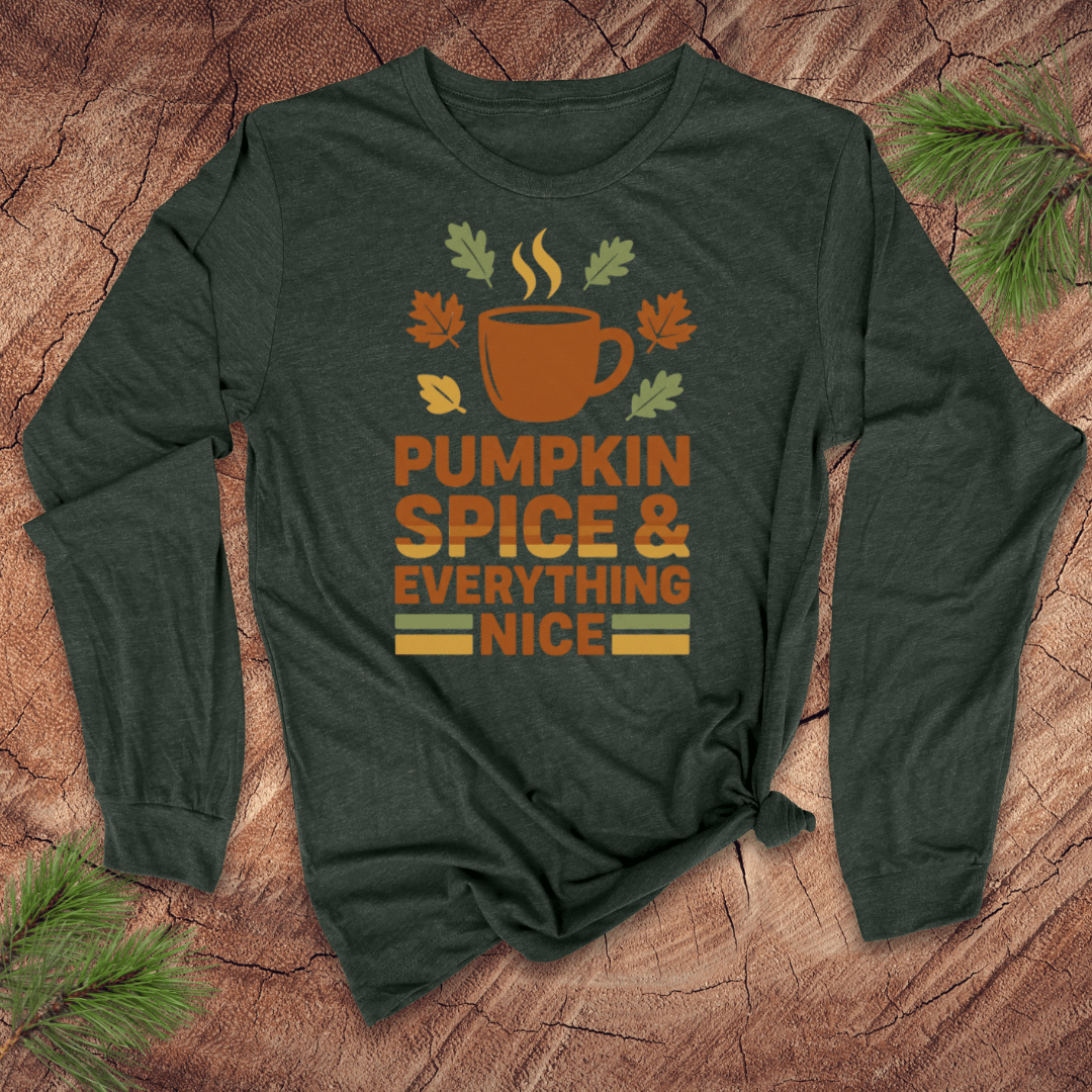 Green long-sleeve shirt with 'Pumpkin Spice & Everything Nice' design on a wooden surface.