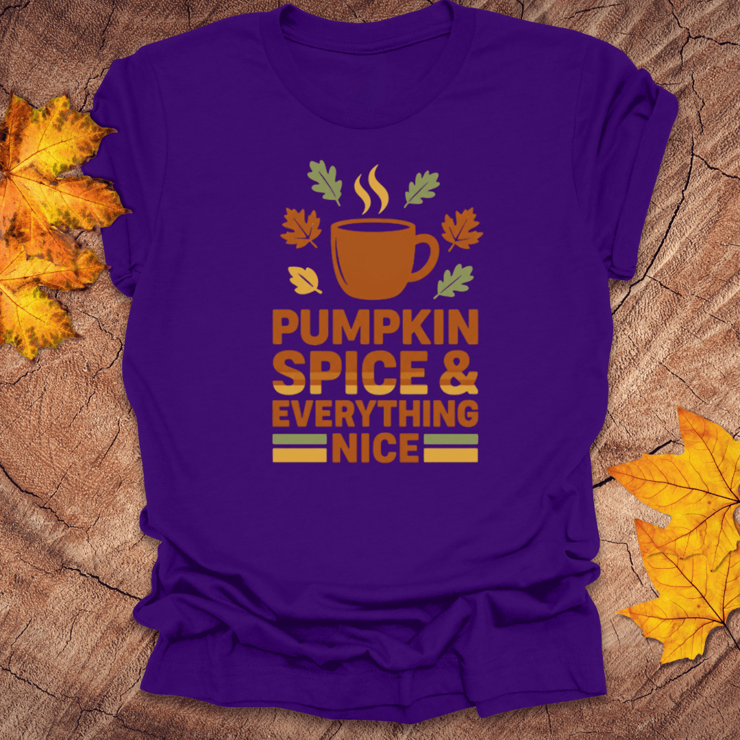 Purple t-shirt with 'Pumpkin Spice & Everything Nice' design on a wooden surface with fall leaves.
