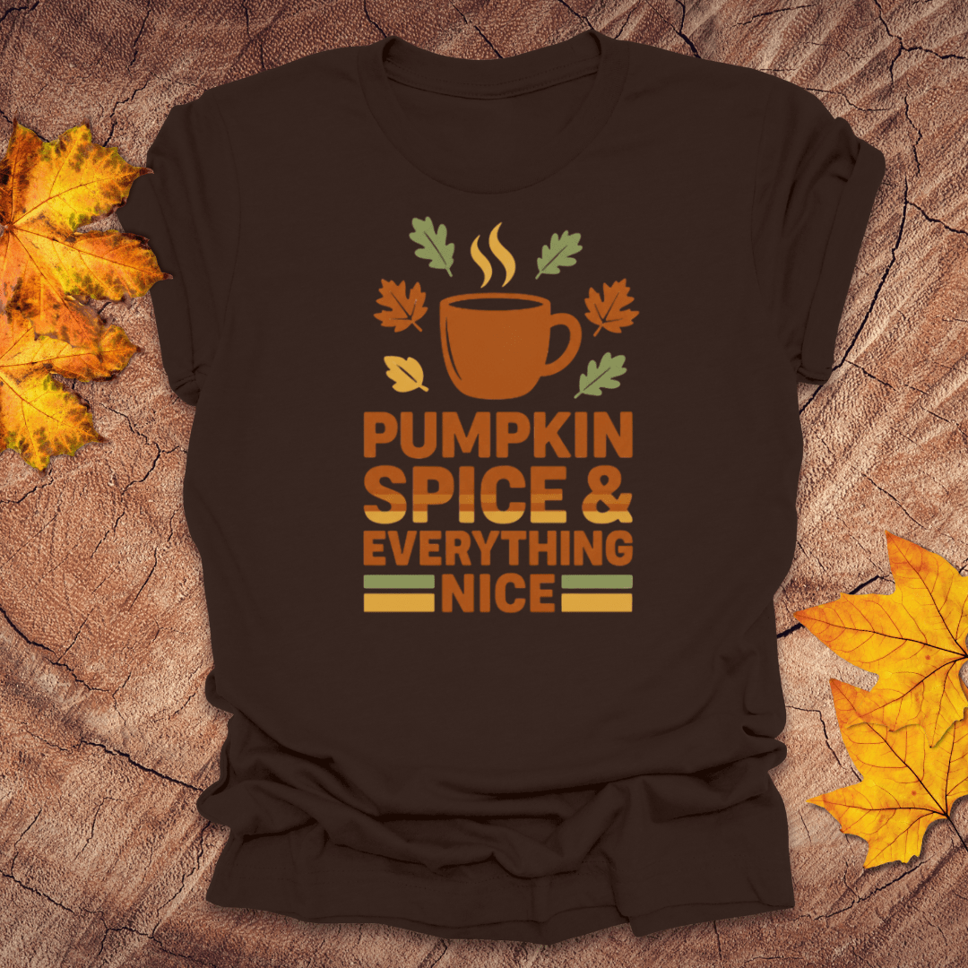 Brown t-shirt with pumpkin spice and everything nice design on a textured surface with fall leaves.