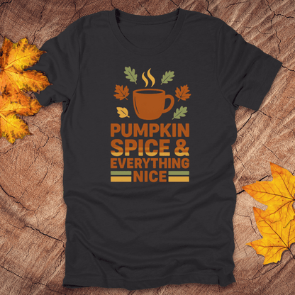 Black t-shirt with pumpkin spice and everything nice design on a wooden surface with fall leaves.