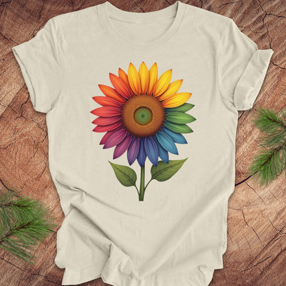 Beige t-shirt with a colorful sunflower design on a wooden surface