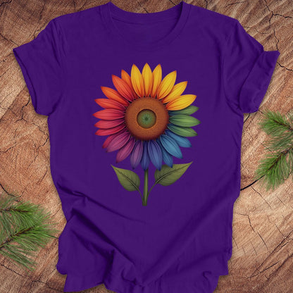 Purple t-shirt with a colorful sunflower design on a wooden surface