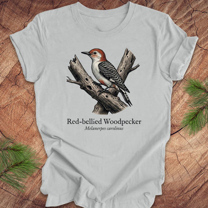 Gray t-shirt with a red-bellied woodpecker graphic and text on a wooden surface.