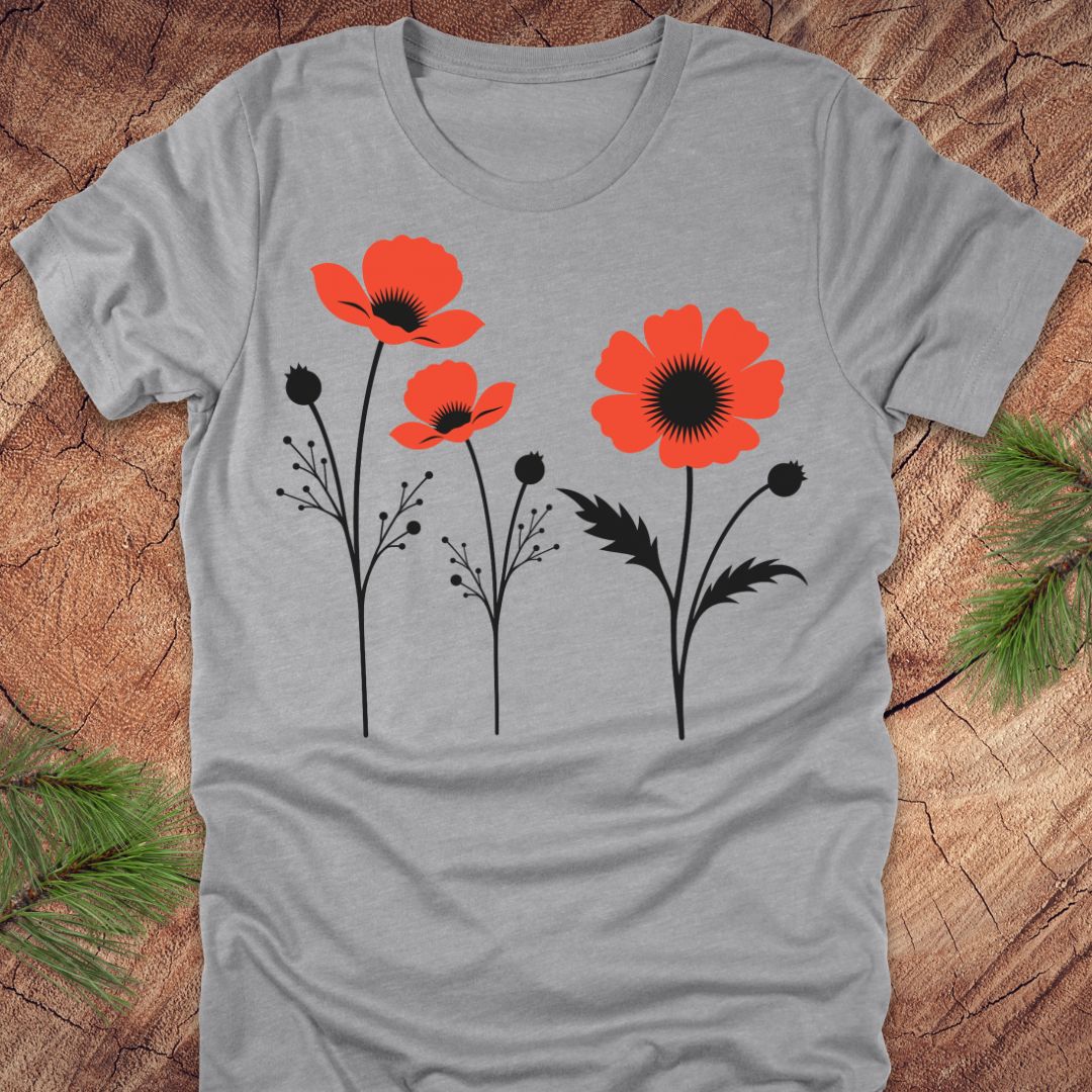 Gray t-shirt with red floral poppy design on a wooden surface
