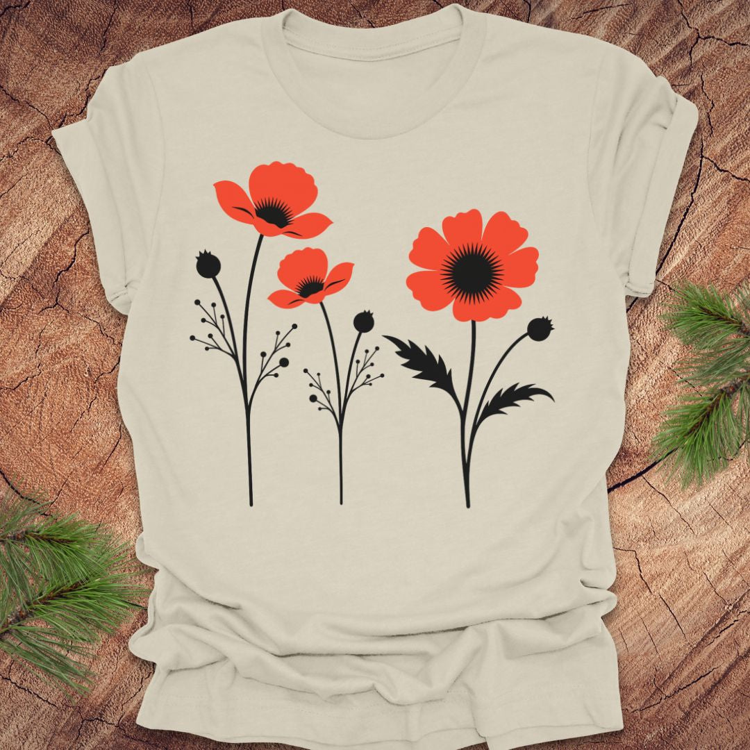 Beige t-shirt with red floral poppy design on a wooden surface