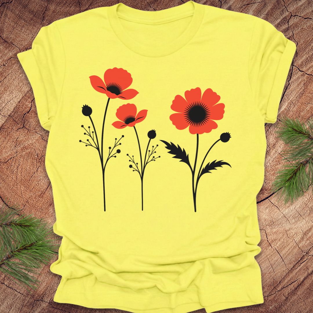 Yellow t-shirt with red floral poppy design on a wooden surface