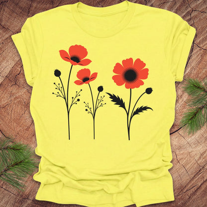 Yellow t-shirt with red floral poppy design on a wooden surface