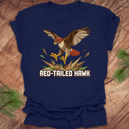 Navy blue t-shirt with a red-tailed hawk graphic on a wooden surface