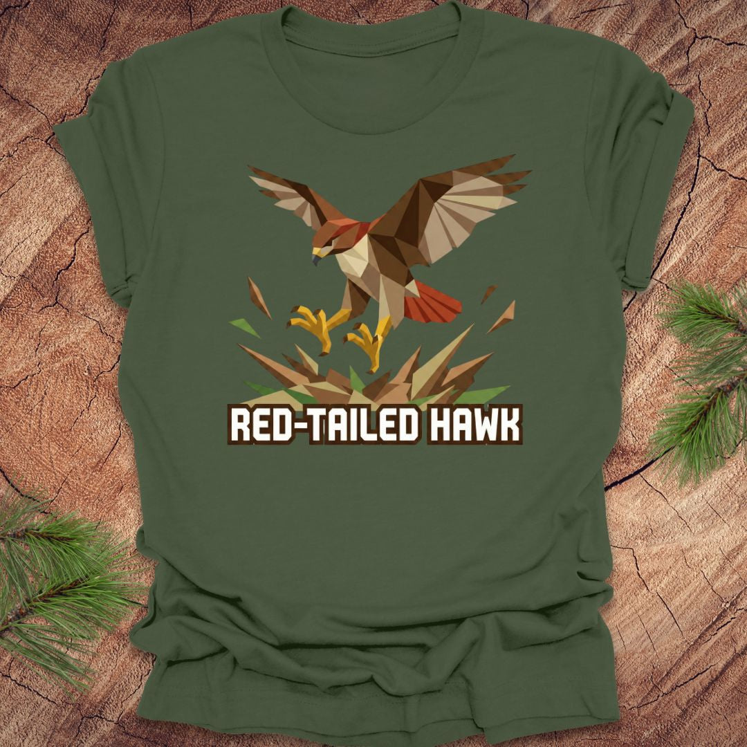 Green t-shirt with a red-tailed hawk design on a wooden surface