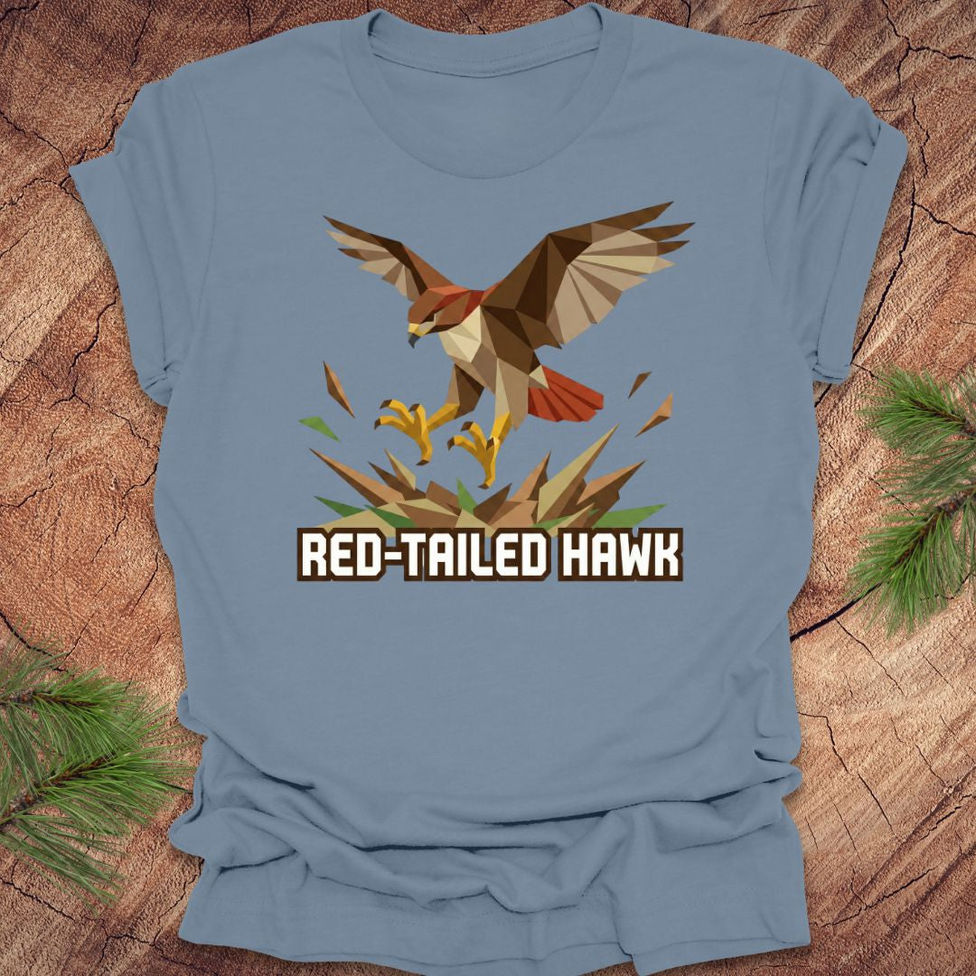 Blue t-shirt with a red-tailed hawk graphic on a wooden surface