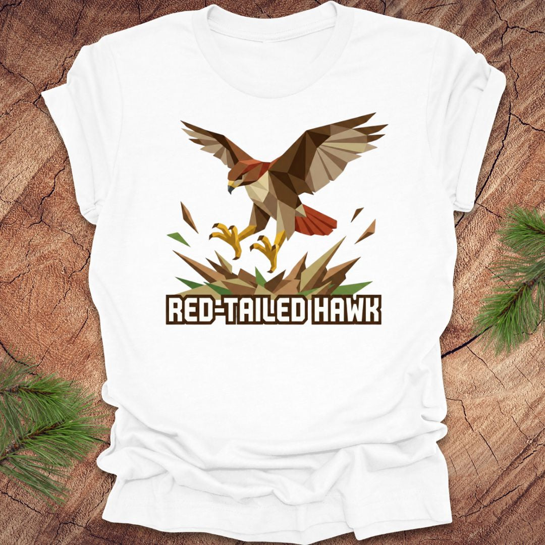 White t-shirt with red-tailed hawk graphic and text on a wooden surface