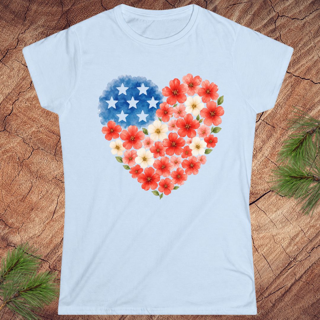 Light blue t-shirt with a heart design featuring American flag stars and red flowers on a wooden surface.