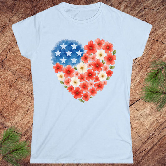 Light blue t-shirt with a heart design featuring American flag stars and red flowers on a wooden surface.