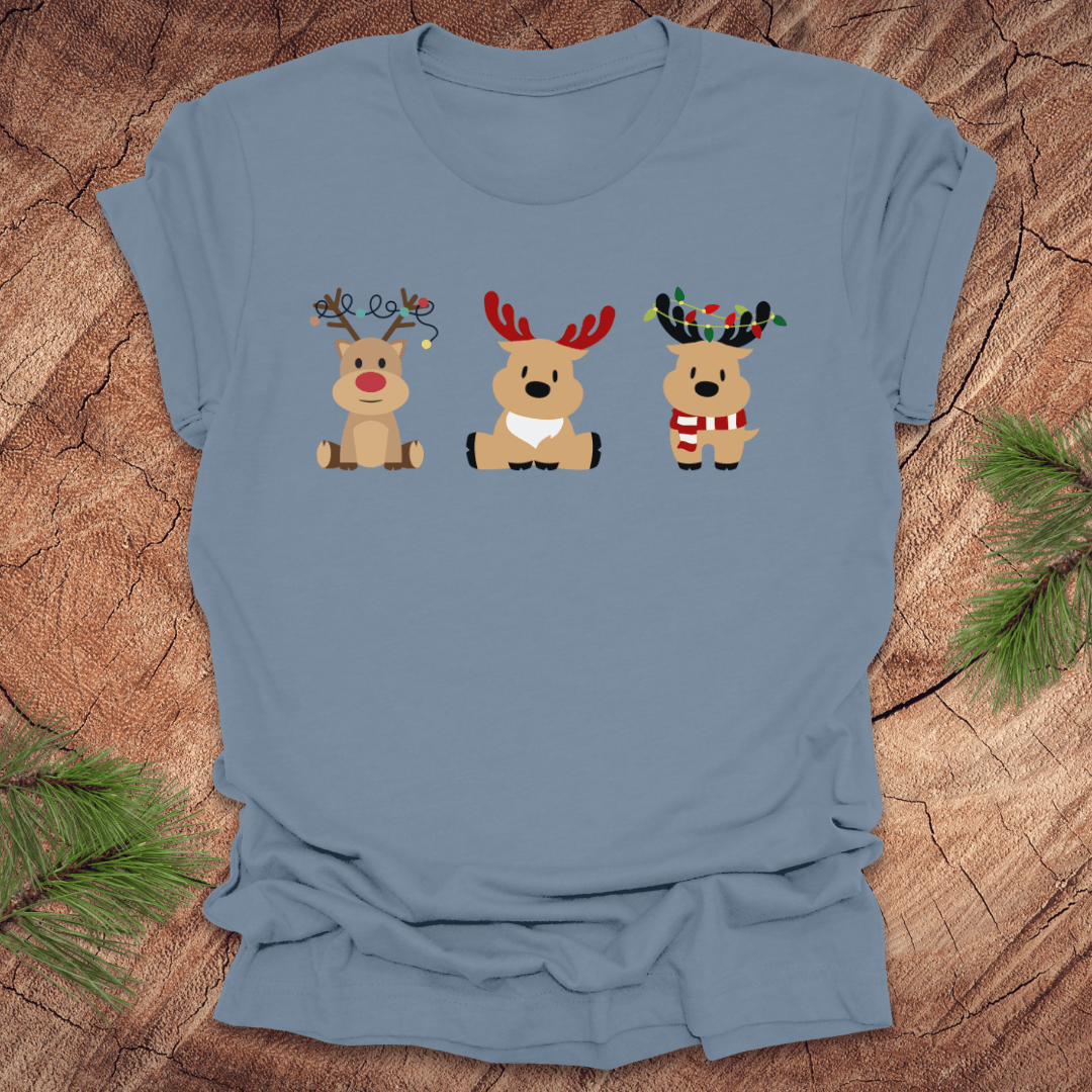Blue t-shirt with cartoon reindeer design on a wooden surface