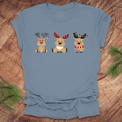 Blue t-shirt with cartoon reindeer design on a wooden surface