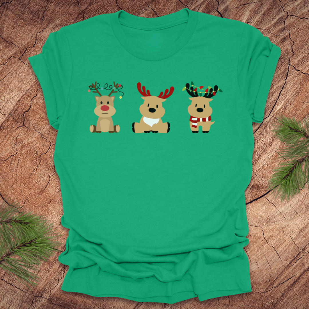 Green t-shirt with cartoon reindeer design on a wooden surface