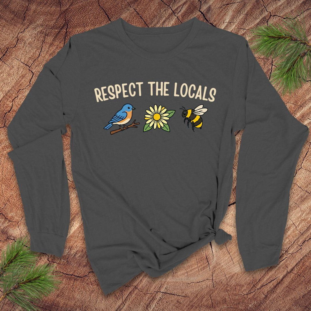 Dark gray long-sleeve shirt with 'Respect the Locals' text and a bird, flower and bee graphics on a wooden surface.