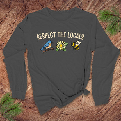 Dark gray long-sleeve shirt with 'Respect the Locals' text and a bird, flower and bee graphics on a wooden surface.