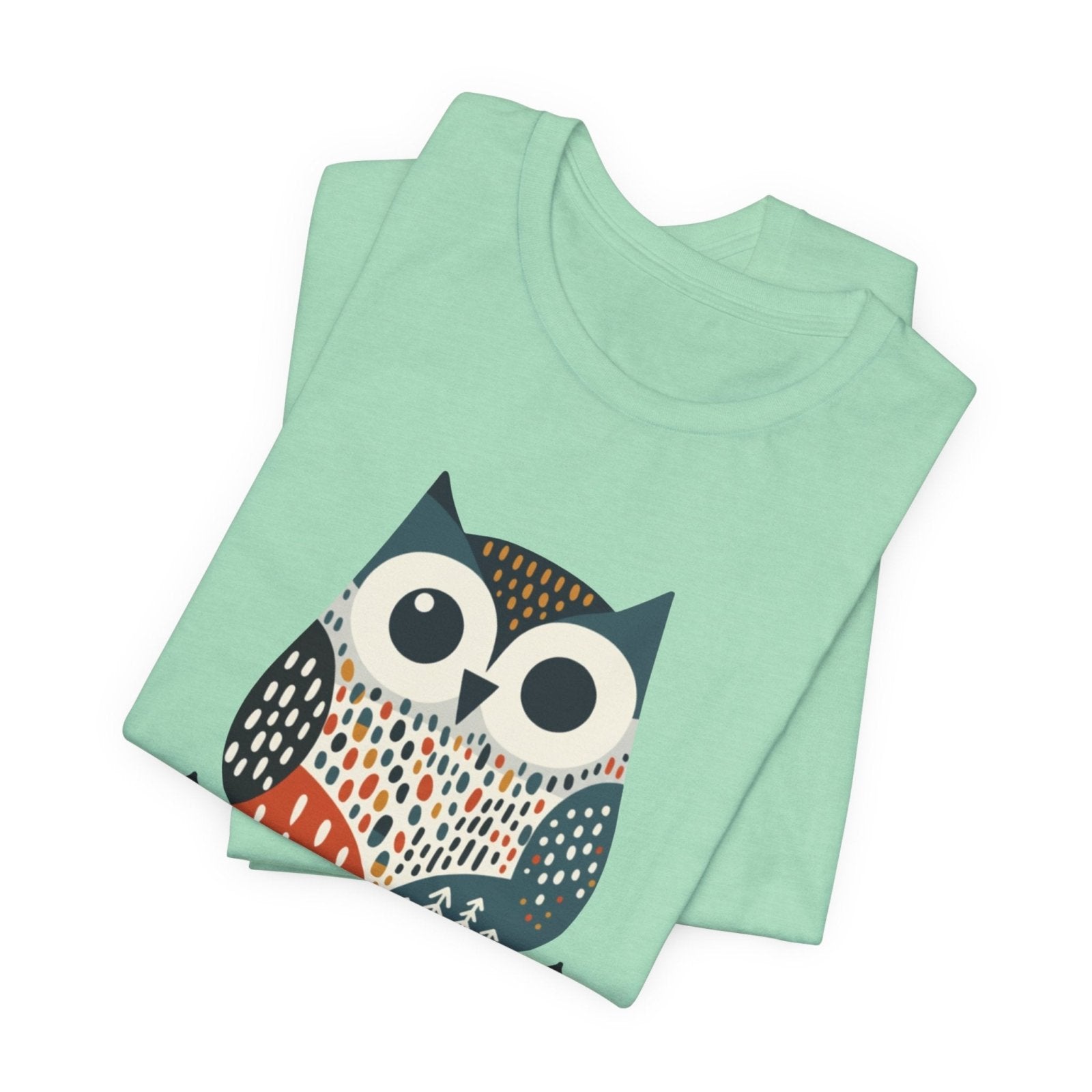 Folded mint green t-shirt with an owl design on a white background