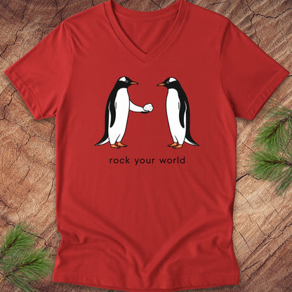 Red v-neck t-shirt with two penguins and text, 'rock your world' on a wood background.