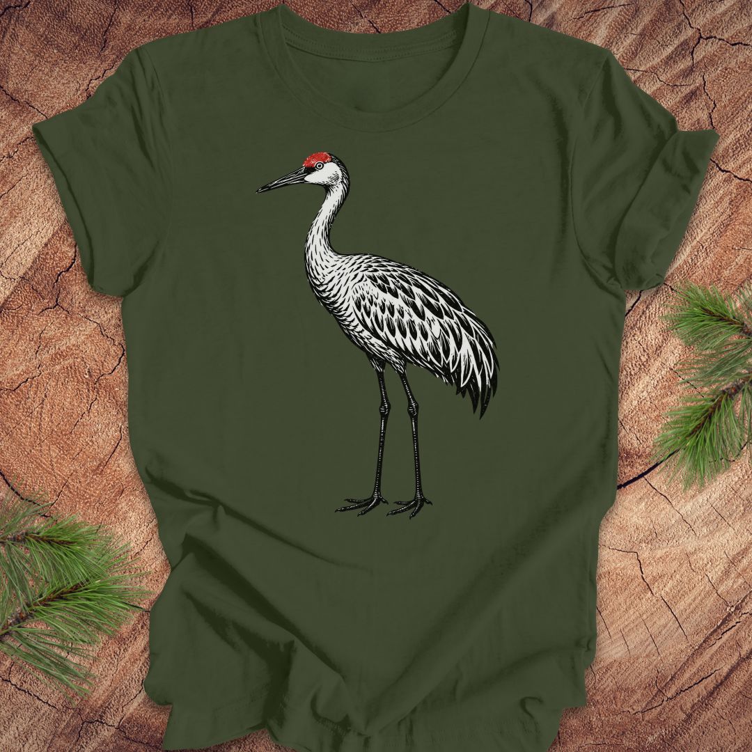 Green t-shirt with a woodcut sandhill crane bird on a wood background.