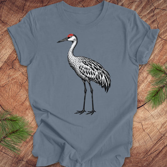 Blue t-shirt with a woodcut sandhill crane bird on a wood background.
