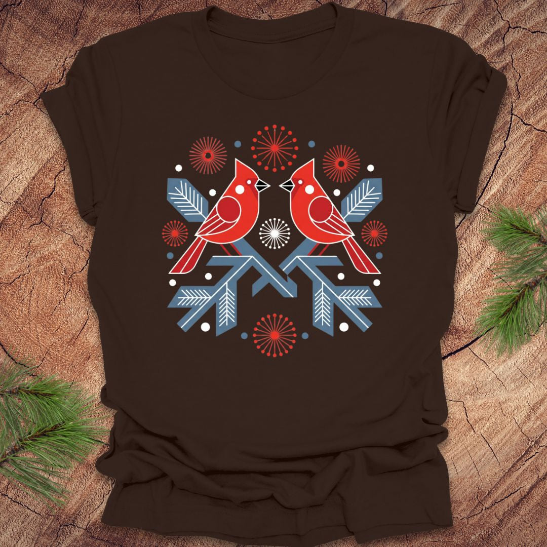 Brown t-shirt with a folk art red cardinal birds design on a wooden surface