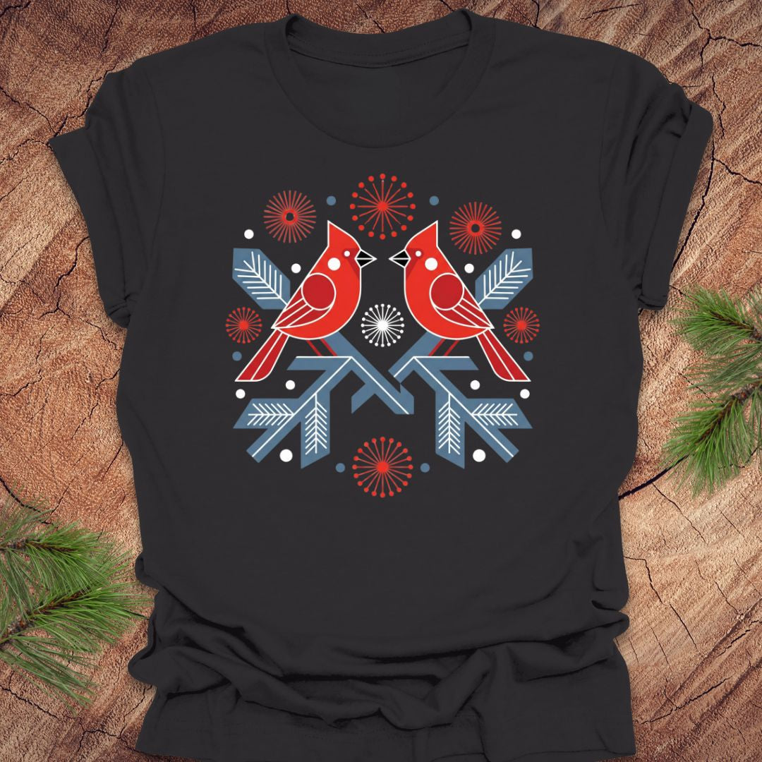 Dark gray t-shirt with a folk art red cardinal birds design on a wooden surface