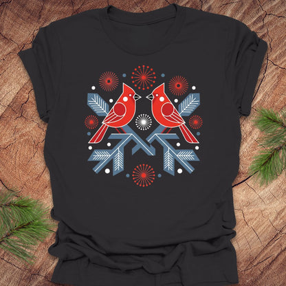 Dark gray t-shirt with a folk art red cardinal birds design on a wooden surface