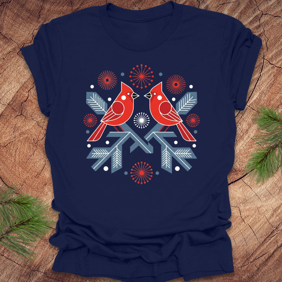 Navy blue t-shirt with a folk art red cardinal birds design on a wooden surface