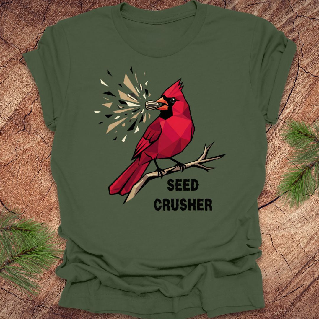 Green t-shirt with a red cardinal graphic and 'Seed Crusher' text on a wooden surface.
