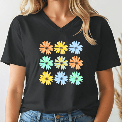 Person wearing a black v-neck t-shirt with colorful daisy flower patterns