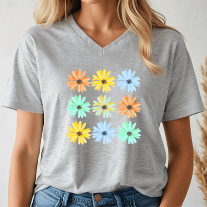 Person wearing a gray v-neck t-shirt with colorful daisy flower patterns