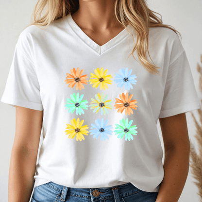 Person wearing a white v-neck t-shirt with colorful daisy flower patterns