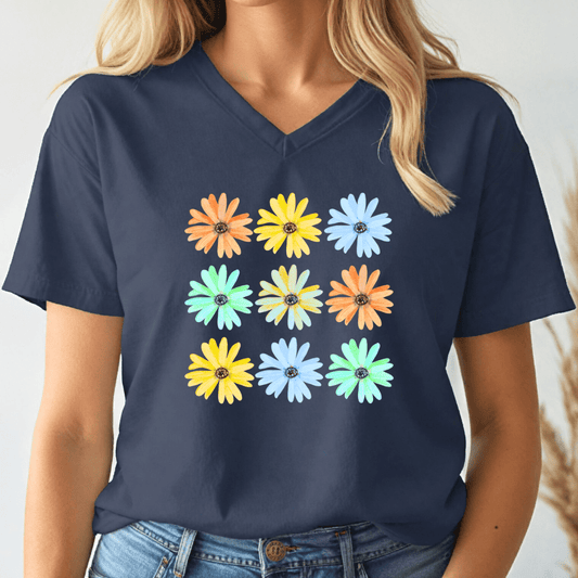 Navy blue v-neck t-shirt with colorful daisy flower pattern worn by a person