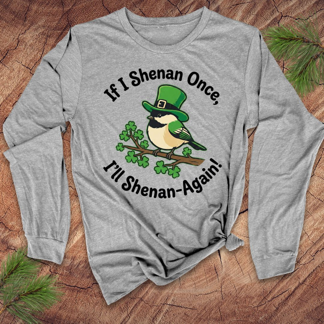 Gray long-sleeve shirt with a bird graphic and text on a wooden surface