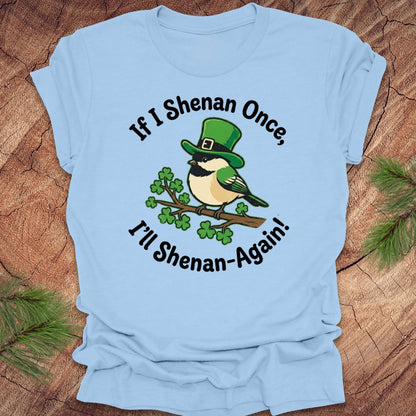 Light blue t-shirt with a st patrick's day bird graphic and text on a wooden surface