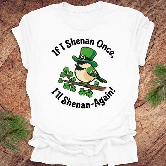 White t-shirt with a st patrick's day bird graphic and text on a wooden surface