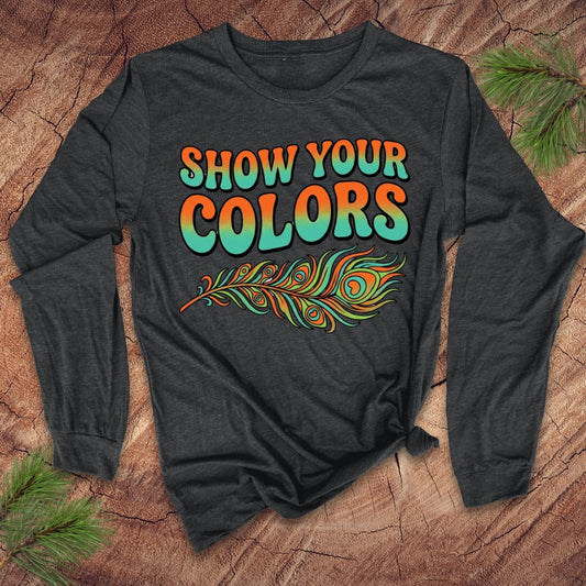 Dark gray long-sleeve shirt with 'Show Your Colors' text and peacock feather design on a wooden surface.