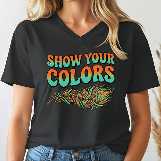 Person wearing a black v-neck t-shirt with 'Show Your Colors' and a peacock feather design.
