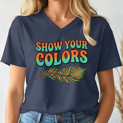 Person wearing a navy blue v-neck t-shirt with 'Show Your Colors' and a peacock feather design.