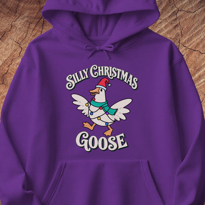 Purple hoodie with a goose in a Santa hat and teal scarf, wrapped in colorful Christmas lights under retro Silly Christmas Goose lettering, laid flat on a rustic wood background.